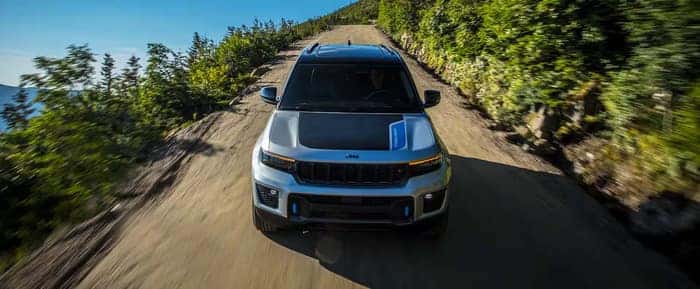 Jeep Grand Cherokee driving on the road facing the front