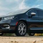 Black Chrysler Pacifica parked in the dirt