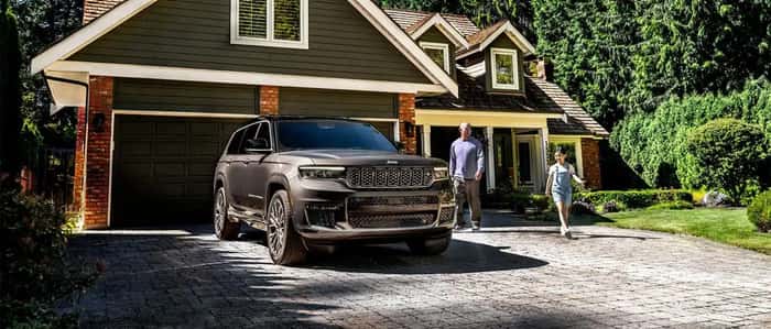 Gray Jeep Grand Cherokee parked in driveway