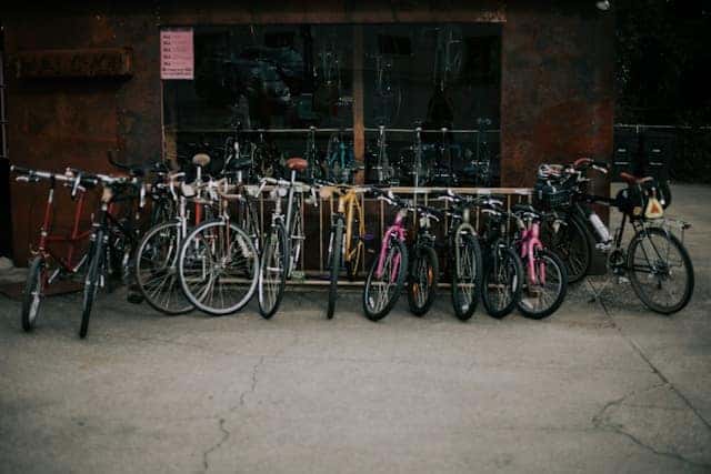 Pile of assorted-color bikes on concrete pavement