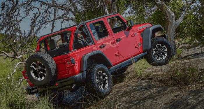 Red 2025 Jeep Wrangler Rubicon driving up hill