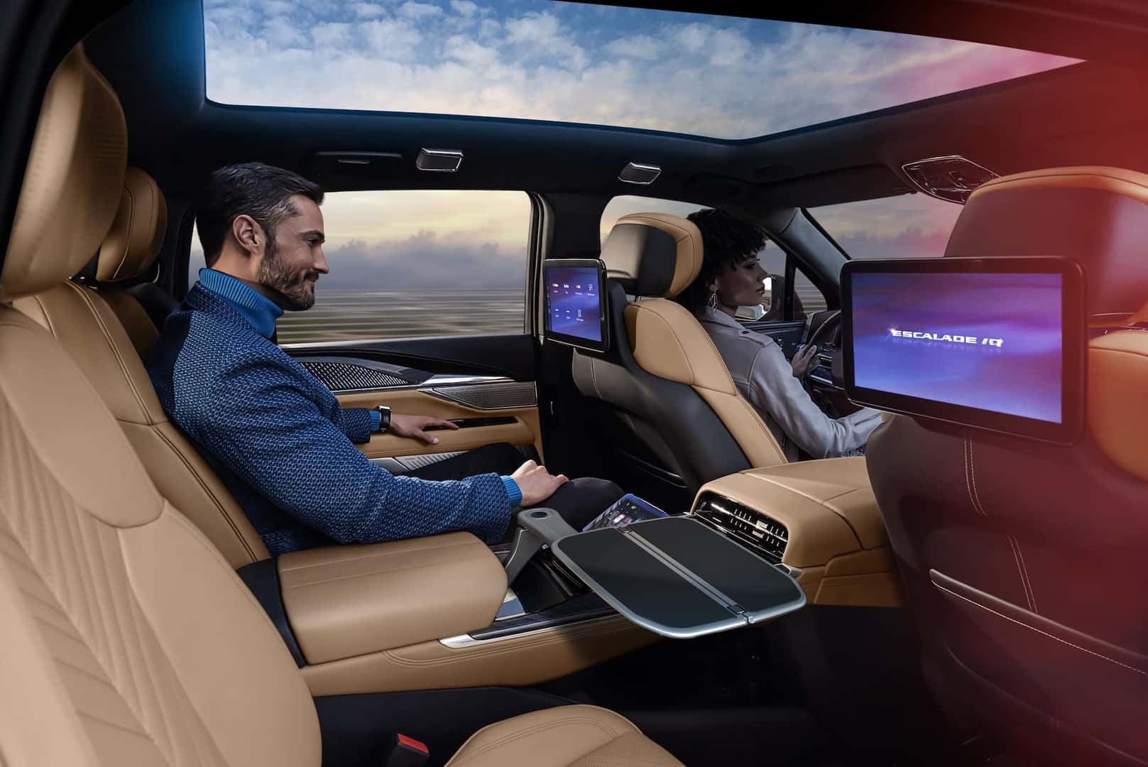Man sitting in Executive Second Row of 2025 Cadillac ESCALADE IQ with backseat screens.