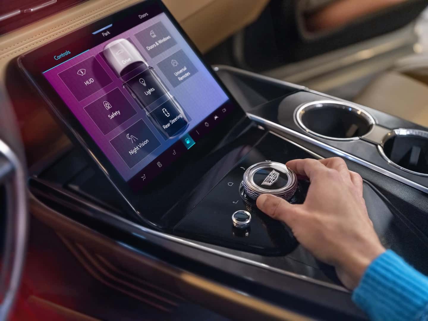 Close-up of man using control console in 2025 Cadillac ESCALADE IQ Sport.
