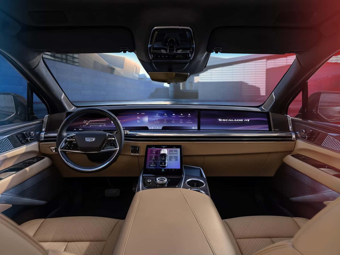 Forward-facing view of 2025 Cadillac ESCALADE IQ interior and 55-inch pillar-to-pillar screen from the rear seat.