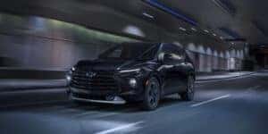2023 Chevy Blazer in all black in a tunnel with headlights on