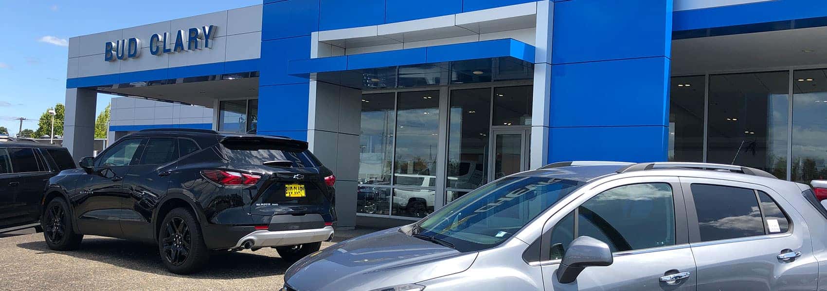 Entrance of Bud Clary Chevrolet in Longview, WA with Chevy cars parked in front