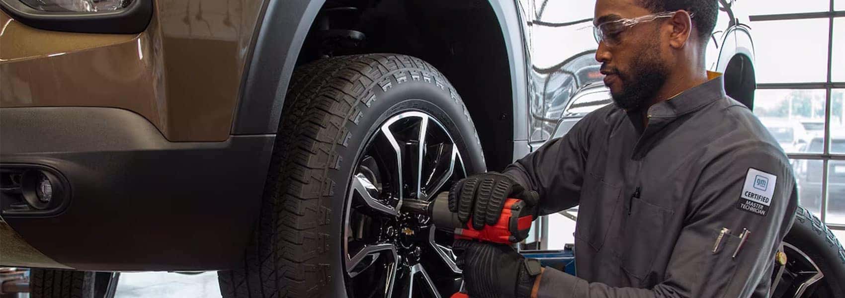 GM Certified Master Technician replacing a tire on a Chevy vehicle