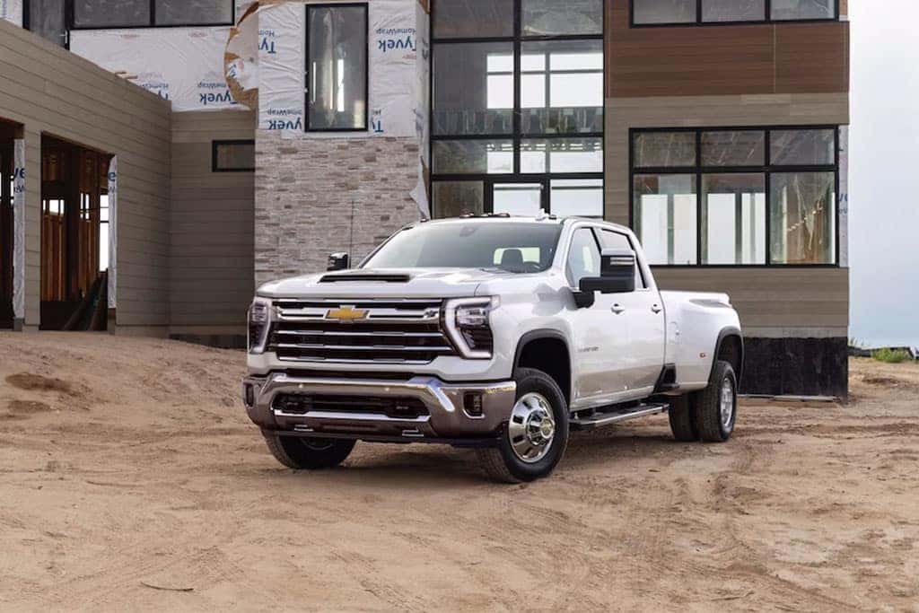 2024 Chevy Silverado 3500 work truck parked at a construction site where a home is being built