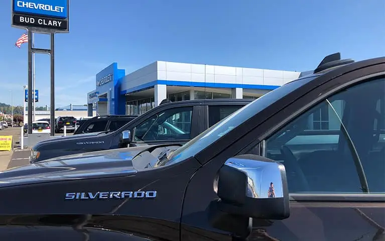 Lineup of Chevy Silverado's at the entrance of Bud Clary Chevrolet in Longview, WA