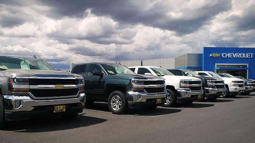 Chevy fleet work trucks in parking lot at Bud Clary Chevrolet in Longview, WA