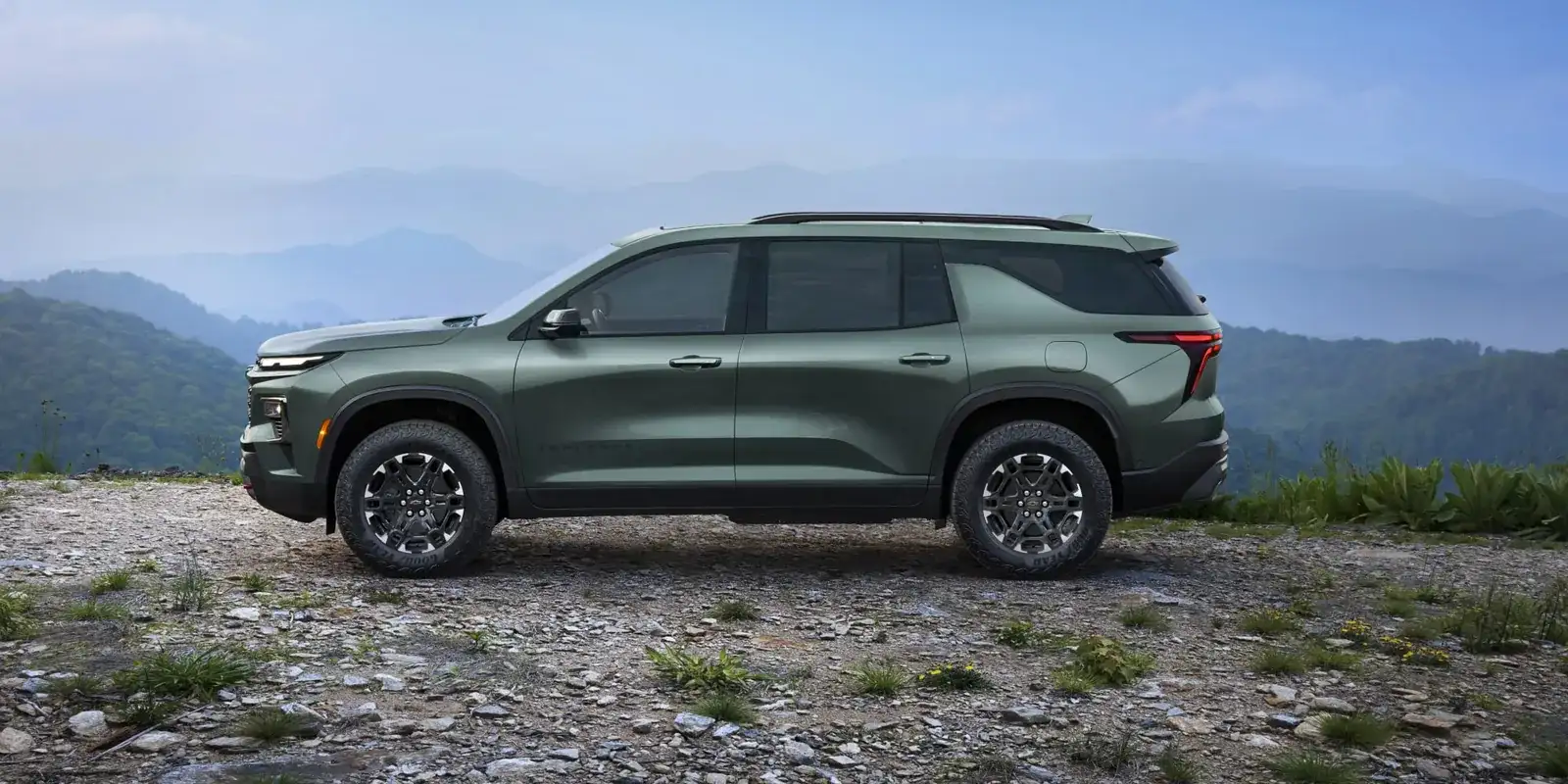 Green 2027 Chevrolet Traverse parked on a mountain overlook