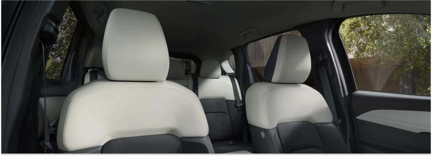 Interior seating of a 2026 Cadillac XT5 featuring two-tone beige and black upholstered seats.