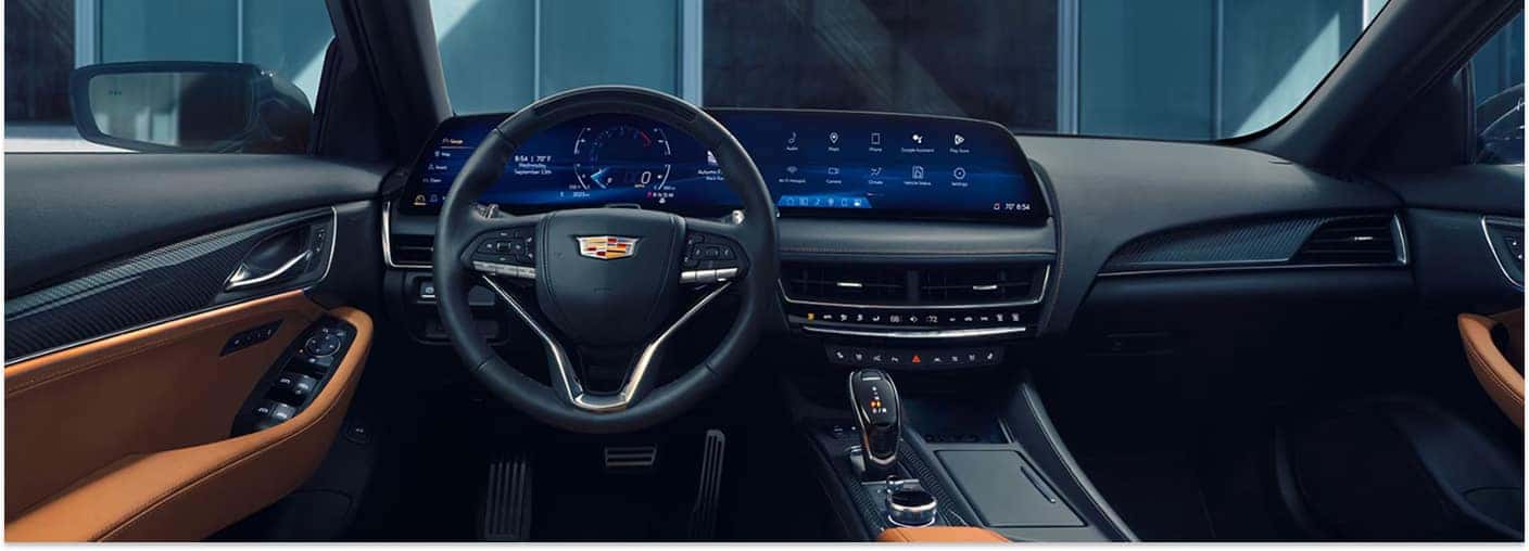 2026 Cadillac CT5 dashboard featuring a 33-inch curved digital display and black and tan interior trim.