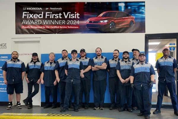 Staff in front of a site