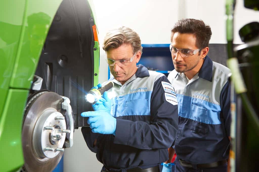 Honda service technicial performing brake inspection and maintenance