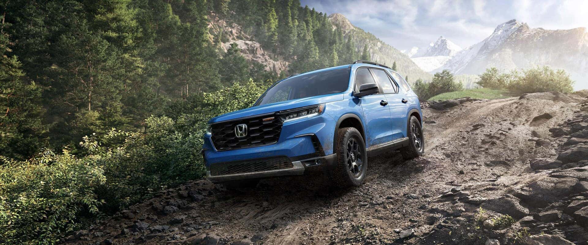 Honda vehicle driving in difficult outdoor terrain