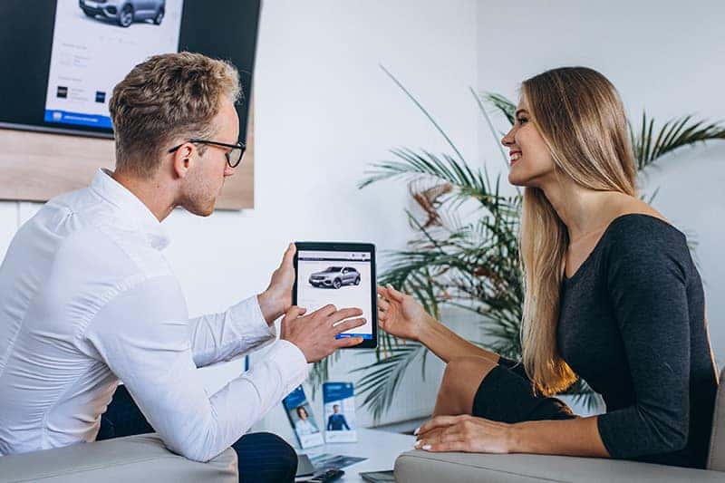 Customer reviewing figures with a Gary Force Honda team member