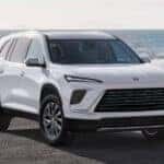 2026 Buick Enclave parked near the ocean showcasing its modern SUV design and signature front grille