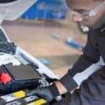 Technician testing a vehicle battery during fall maintenance service at Greg Hubler Buick GMC in Marion, Indiana