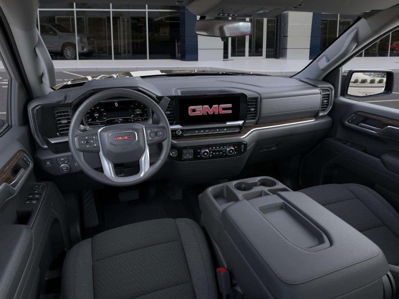 Interior view of the 2025 GMC Sierra 1500 cabin with touchscreen and driver display