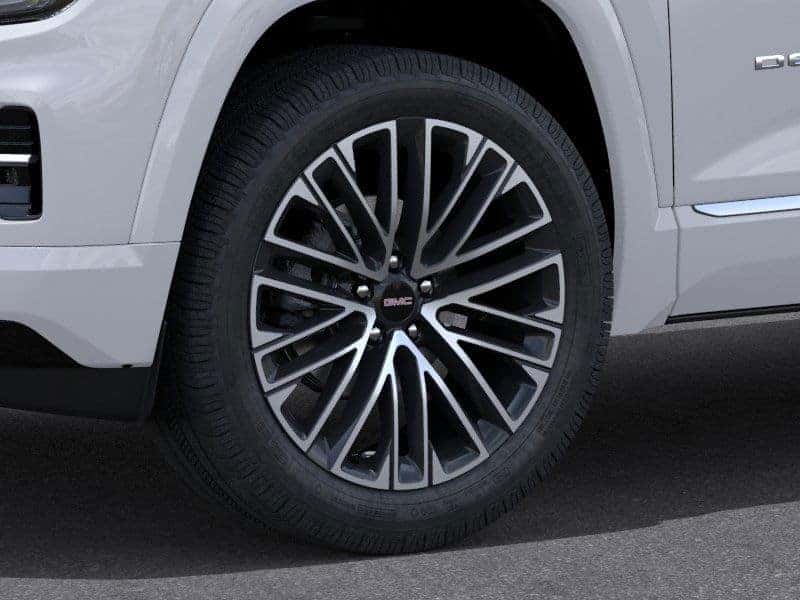 Close up of GMC Terrain Denali wheel design in front of Greg Hubler Buick GMC