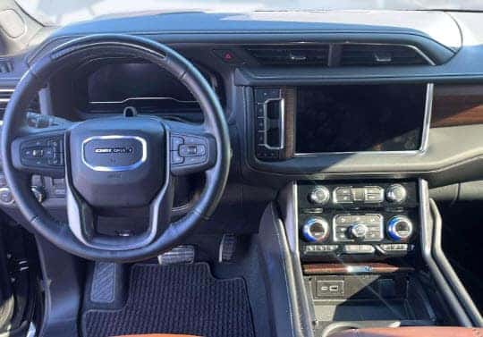 Interior of a used GMC Yukon Denali showing premium dashboard and infotainment features