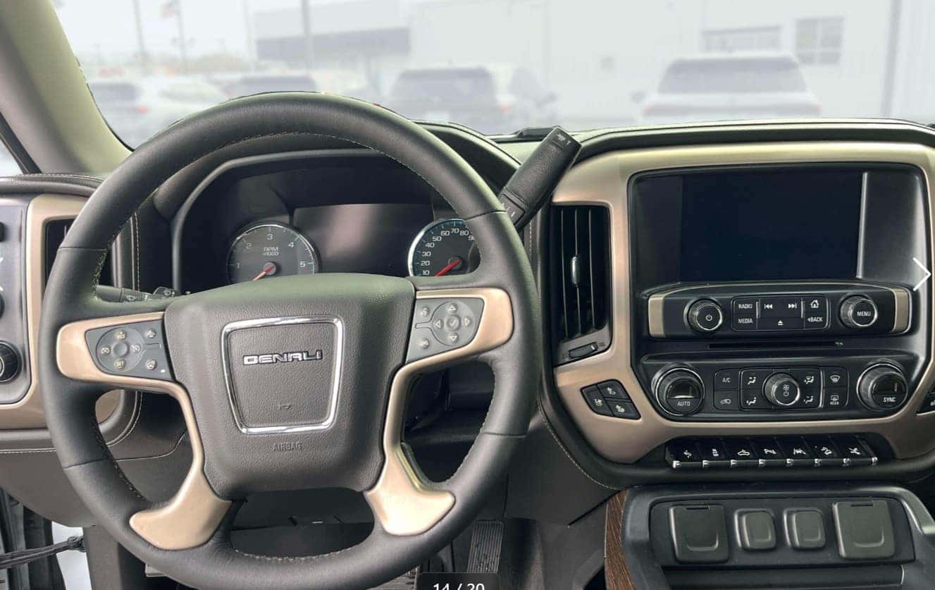 Interior of a used GMC Sierra truck with technology and comfort features