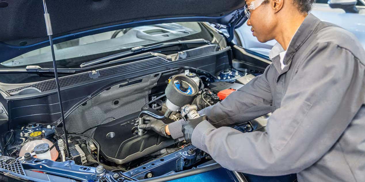 GMC Certified Technician Performing an Oil Change on a Sierra 1500