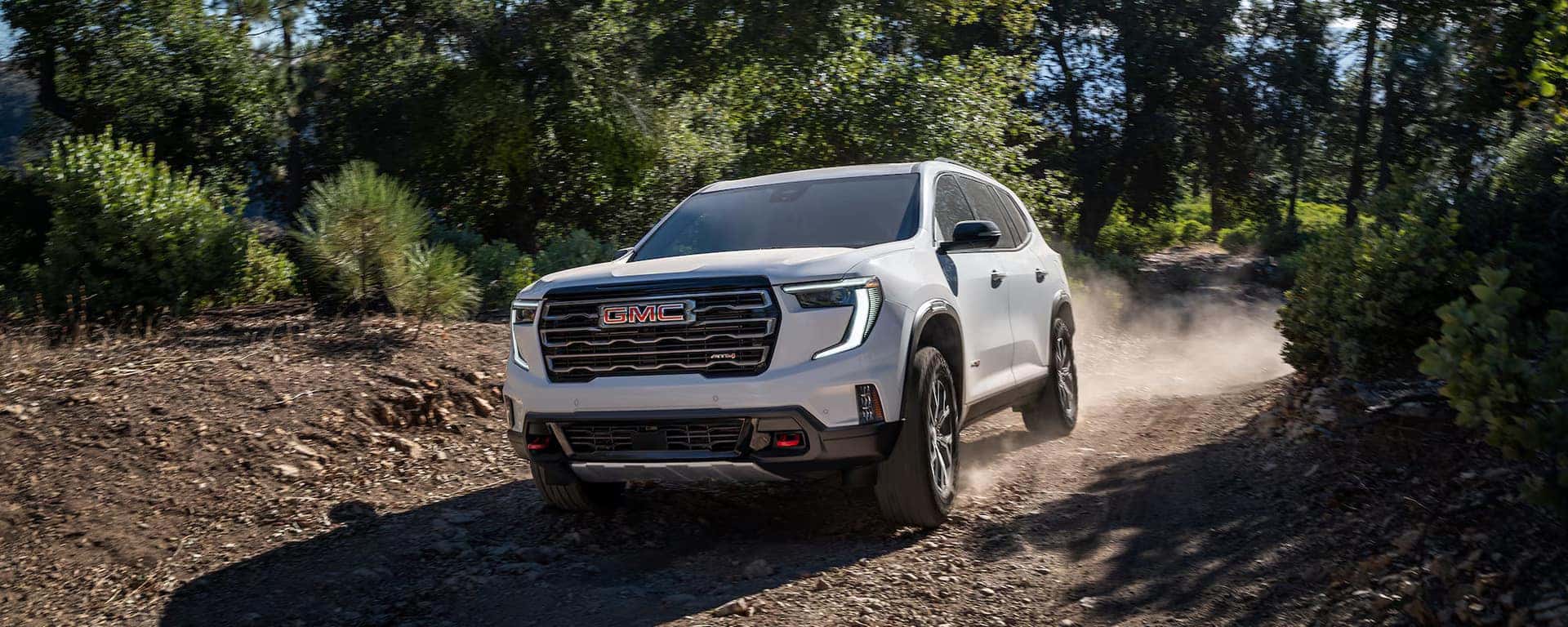 2026 GMC Acadia AT4 navigating a rugged dirt trail