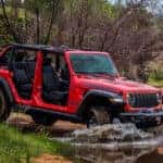 2025 Jeep Wrangler Driving Off Road Through Mud