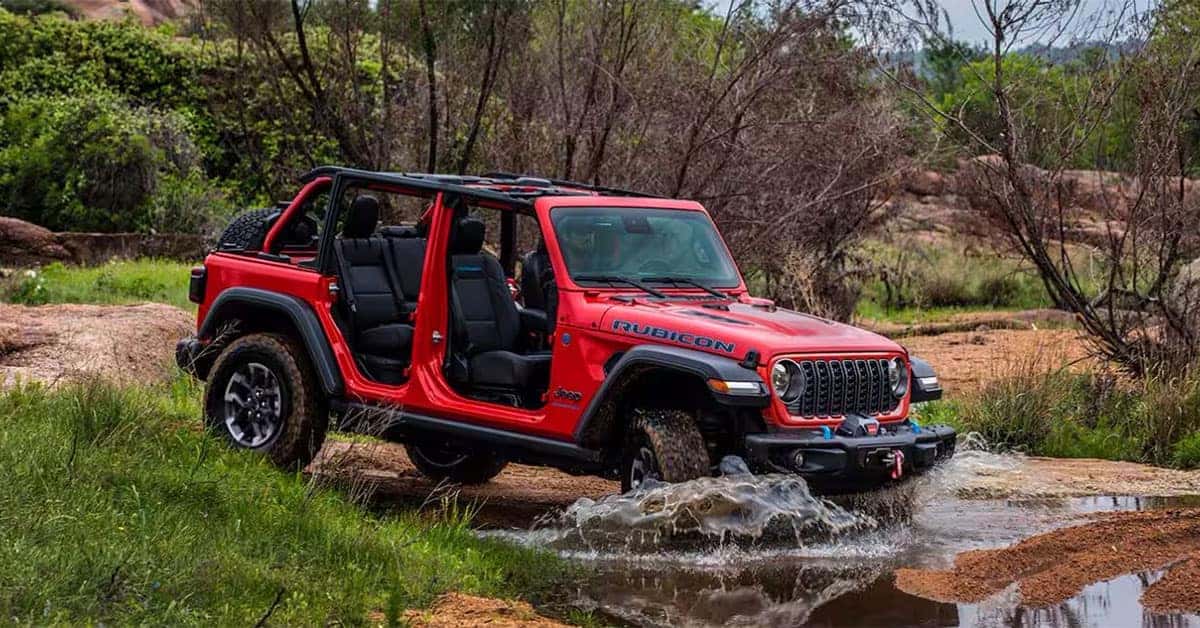 2025 Jeep Wrangler Driving Off Road Through Mud