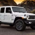 2025 Jeep Wrangler exterior parked in a desert in front of mountains