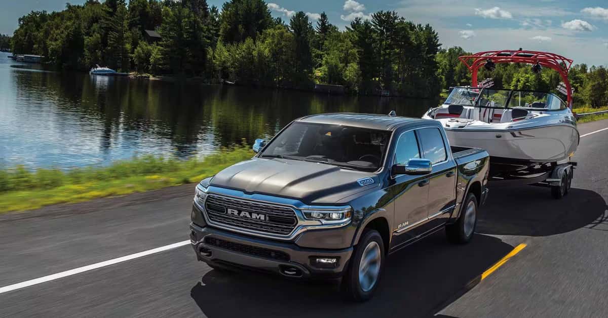 2024 Ram 1500 towing a boat near a lake