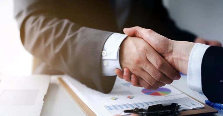 Finance manager reviewing a vehicle financing deal with a customer
