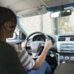 A woman drives her Honda vehicle with Honda sensing