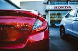 The rear end of a red Honda vehicle