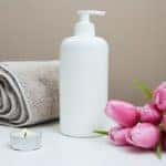A towel, flowers, and bottle of lotion for a massage sessions at spa in Marion, Illinois