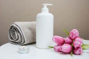 A towel, flowers, and bottle of lotion for a massage sessions at spa in Marion, Illinois
