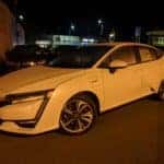 A white Honda Clarity Plug In at a charging station