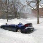 A vehicle is stuck under a mound of snow in Marion, Illinois