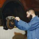 A technicians checks for signs the brake pads are worn out at a Marion, Illinois brake service center
