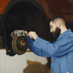 Car mechanic working on car brake pads in Marion, IL.