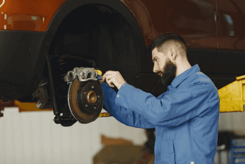 Car mechanic working on car brake pads in Marion, IL.