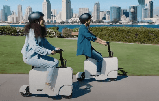 Honda Motocompacto drivers riding the scooter in the city.