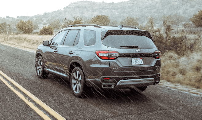 2024 Honda Pilot driving through rain on a Marion, IL road.