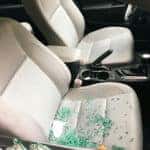 broken car window glass on a car seat