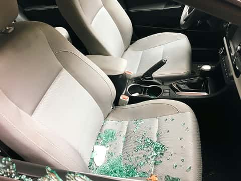 broken car window glass on a car seat