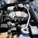 Close up of a open honda front hood exposing the engine bay.