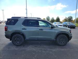 green 2026 Honda Passport SUV parked at the Ike Honda dealership in Marion, IL