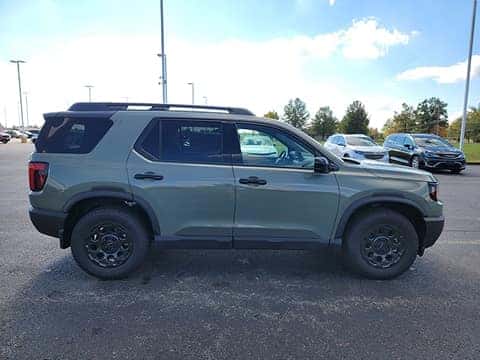 green 2026 Honda Passport SUV parked at the Ike Honda dealership in Marion, IL